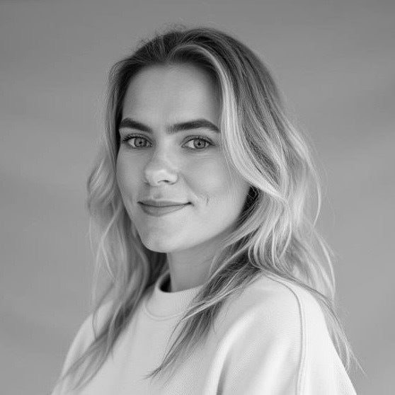 A white woman with blonde hair looks passively at the camera.  Black and white photo