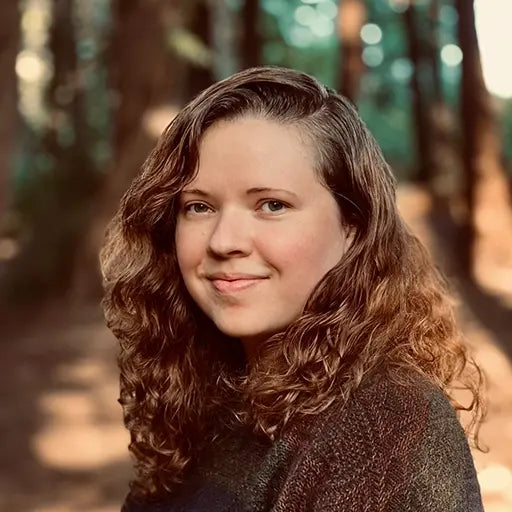 Photo of Mackenzie Lisenby, a white woman with reddish brown hair and dark eyes